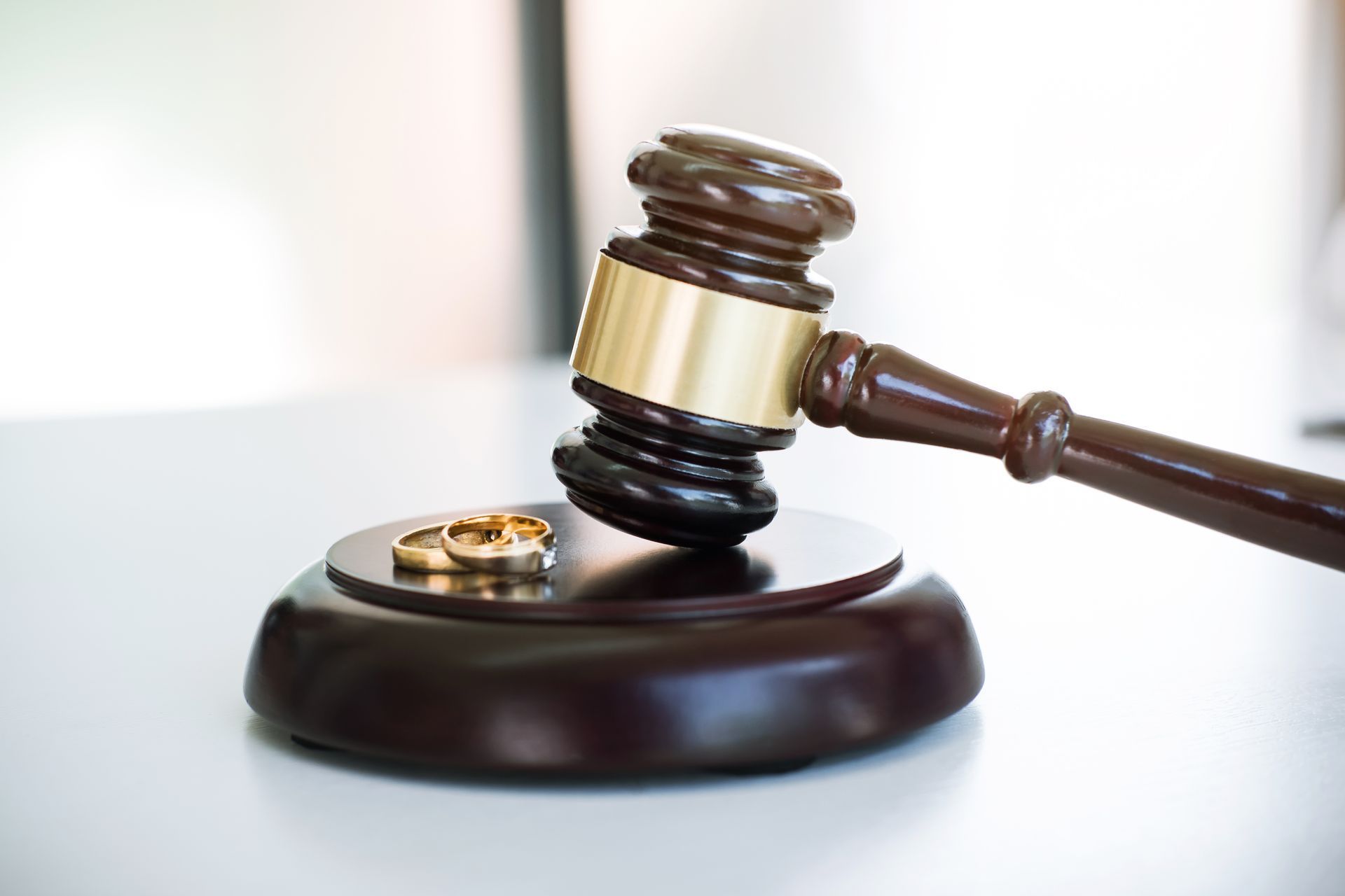 Judge’s gavel on a wooden sound block with a gold ring, symbolizing a court ruling.
