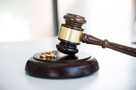 Judge’s gavel on a wooden sound block with a gold ring, symbolizing a court ruling.