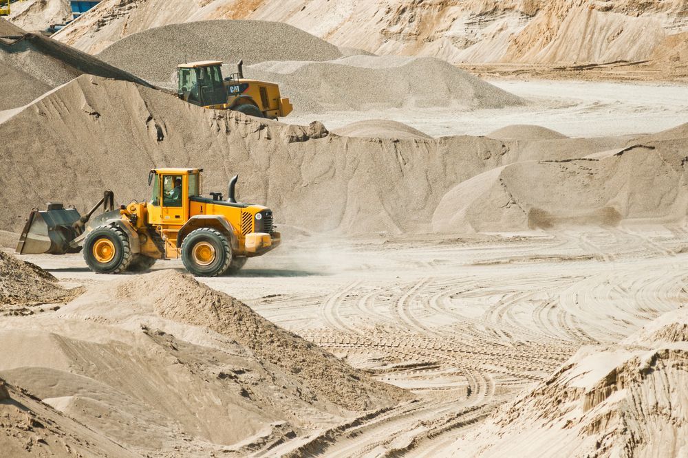 A Yellow Bulldozer is Driving Through a Sand Field — Hothams In Bathurst, NSW