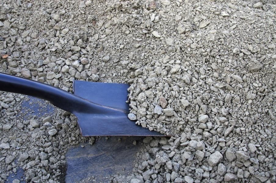 A Shovel is Sitting on Top of a Pile of Gravel — Hothams In Lithgow, NSW