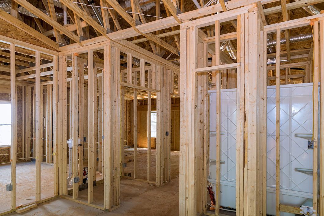 The inside of a house under construction with wooden beams.