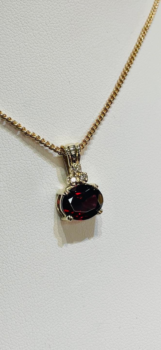 Gold Necklace With a Dark Red Gemstone Pendant — Chris Williams Retail & Manufacturing Jewellers in Wanguri, NT