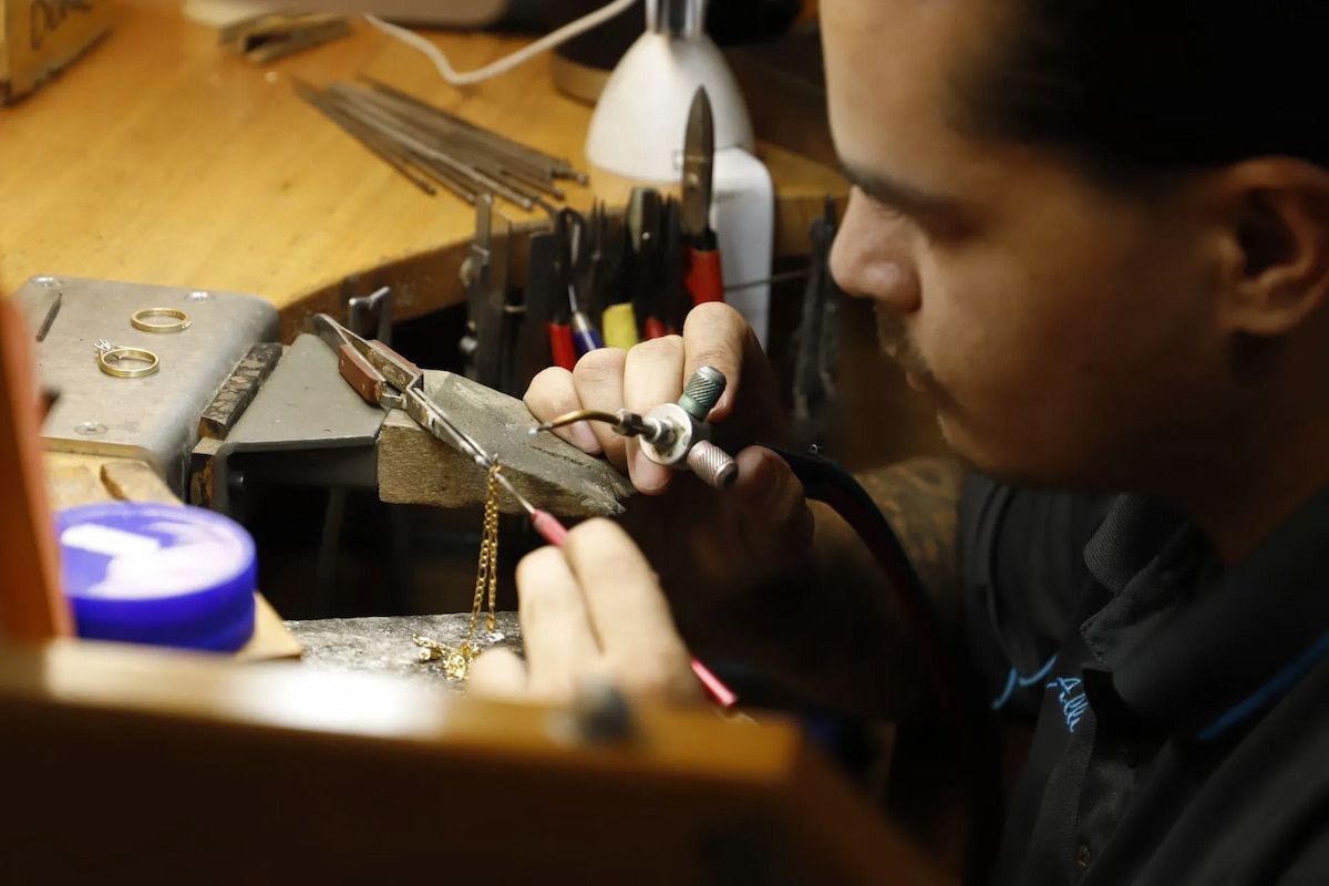 Jeweler Soldering a Necklace, Focused at His Workbench — Chris Williams Retail & Manufacturing Jewellers in Wanguri, NT
