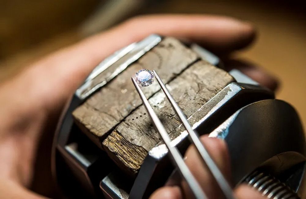 Jeweler's Hands Holding a Diamond With Tweezers — Chris Williams Retail & Manufacturing Jewellers in Wanguri, NT