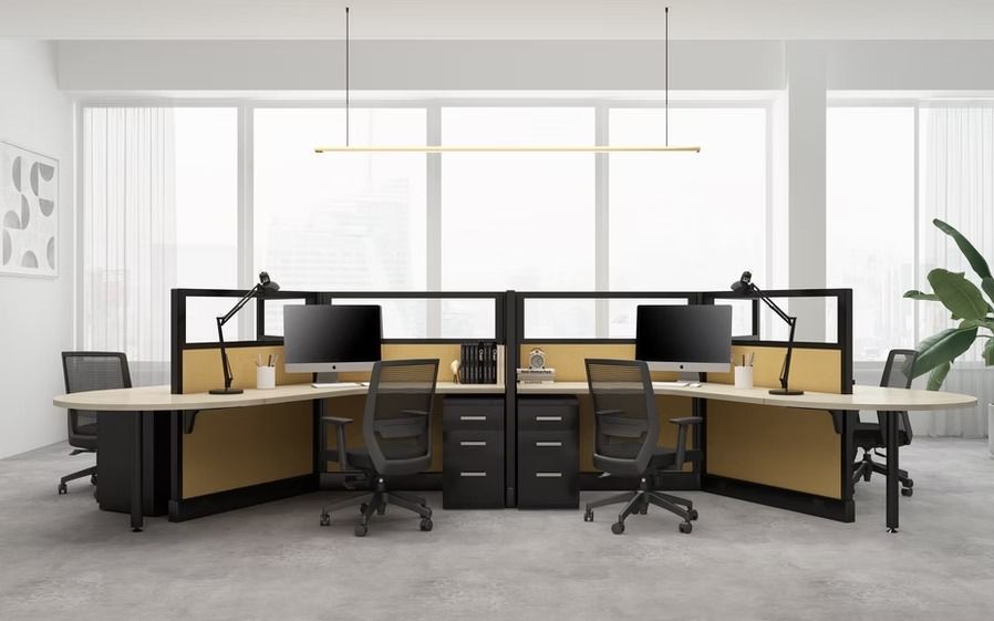 A row of cubicles with computers and chairs in an office.