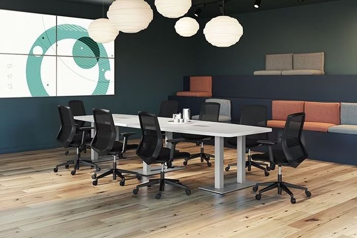 A conference room with a long table and chairs.