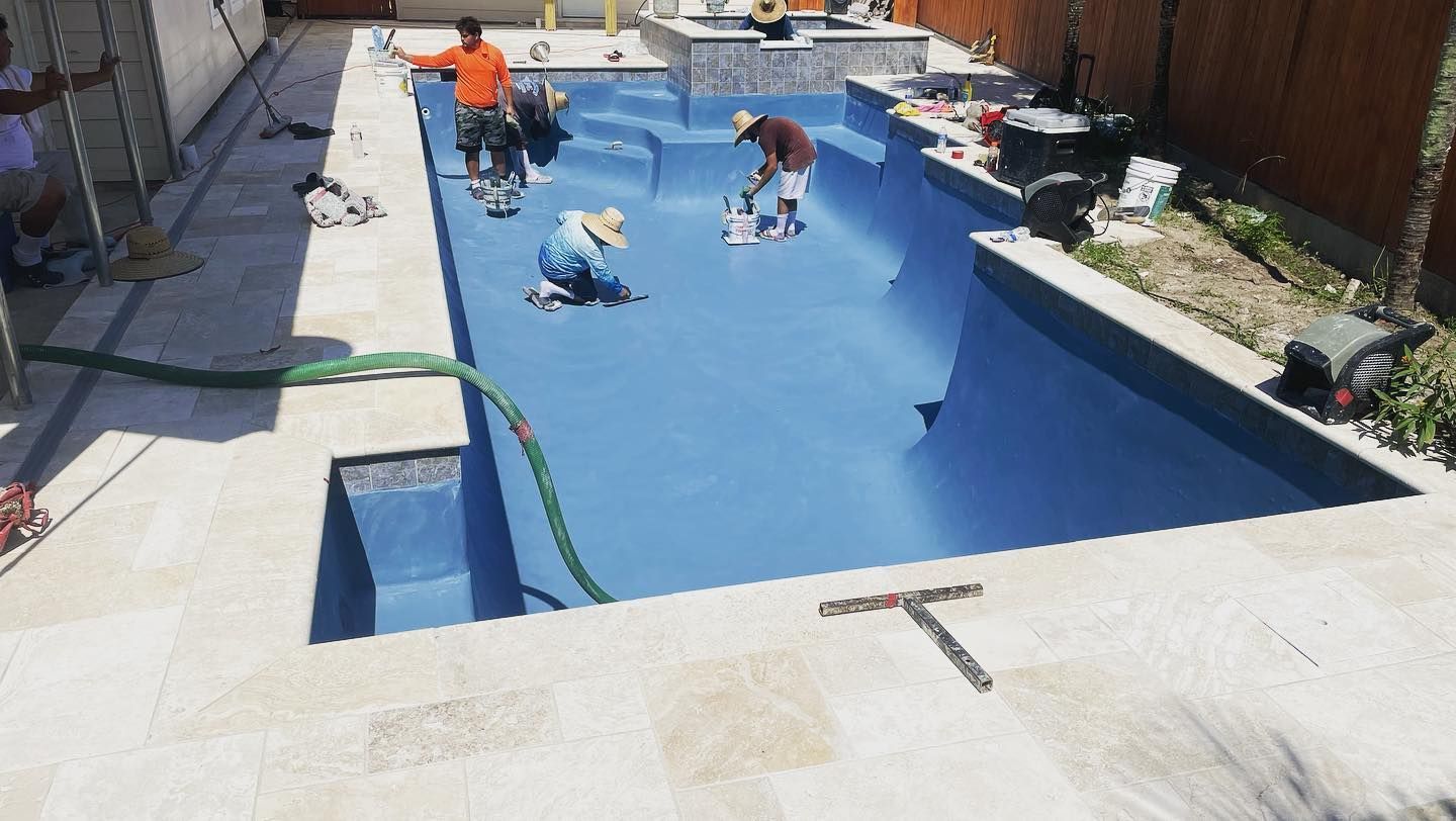 Children playing in a blue backyard pool with an adult nearby on a sunny day