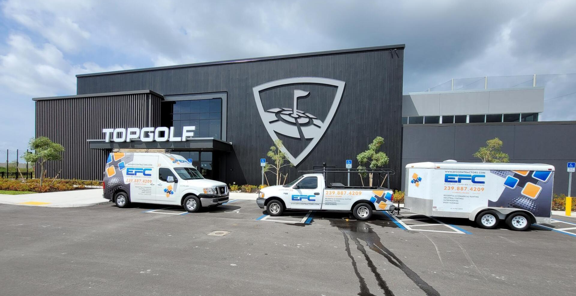 A white van, truck, and trailer with the 