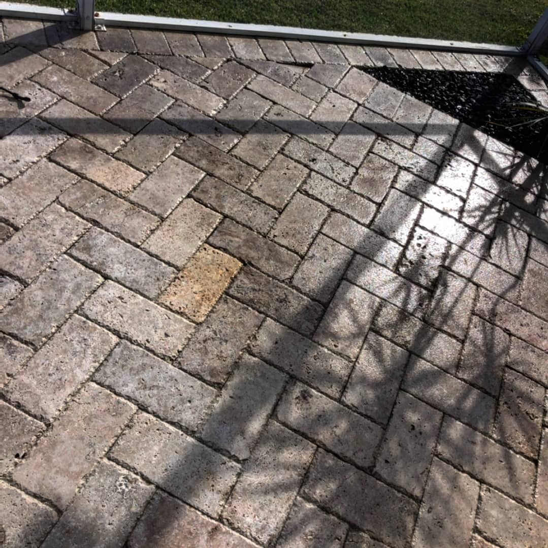 Herringbone pattern brick patio with shadows.