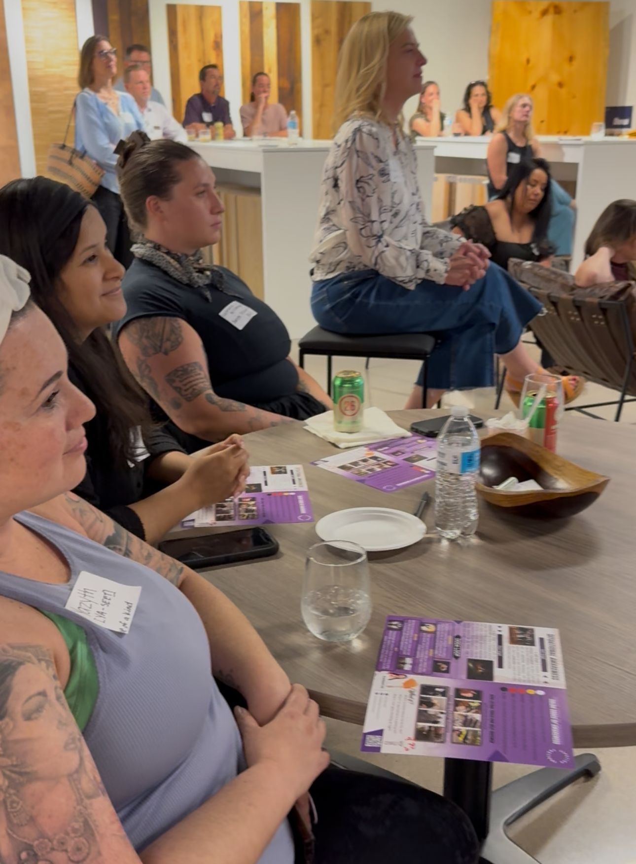 People seated in a meeting room, listening to a speaker during a workshop.