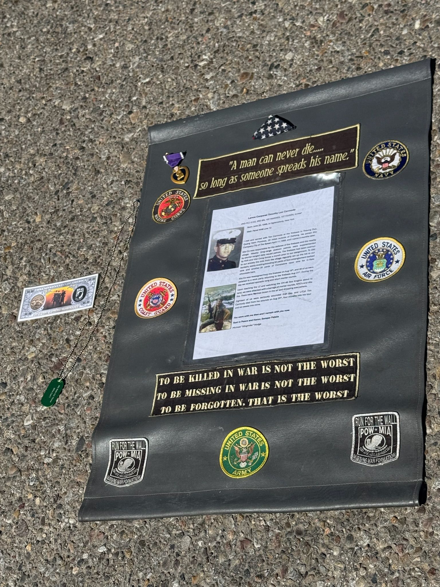 A piece of paper with badges on it is laying on the ground.