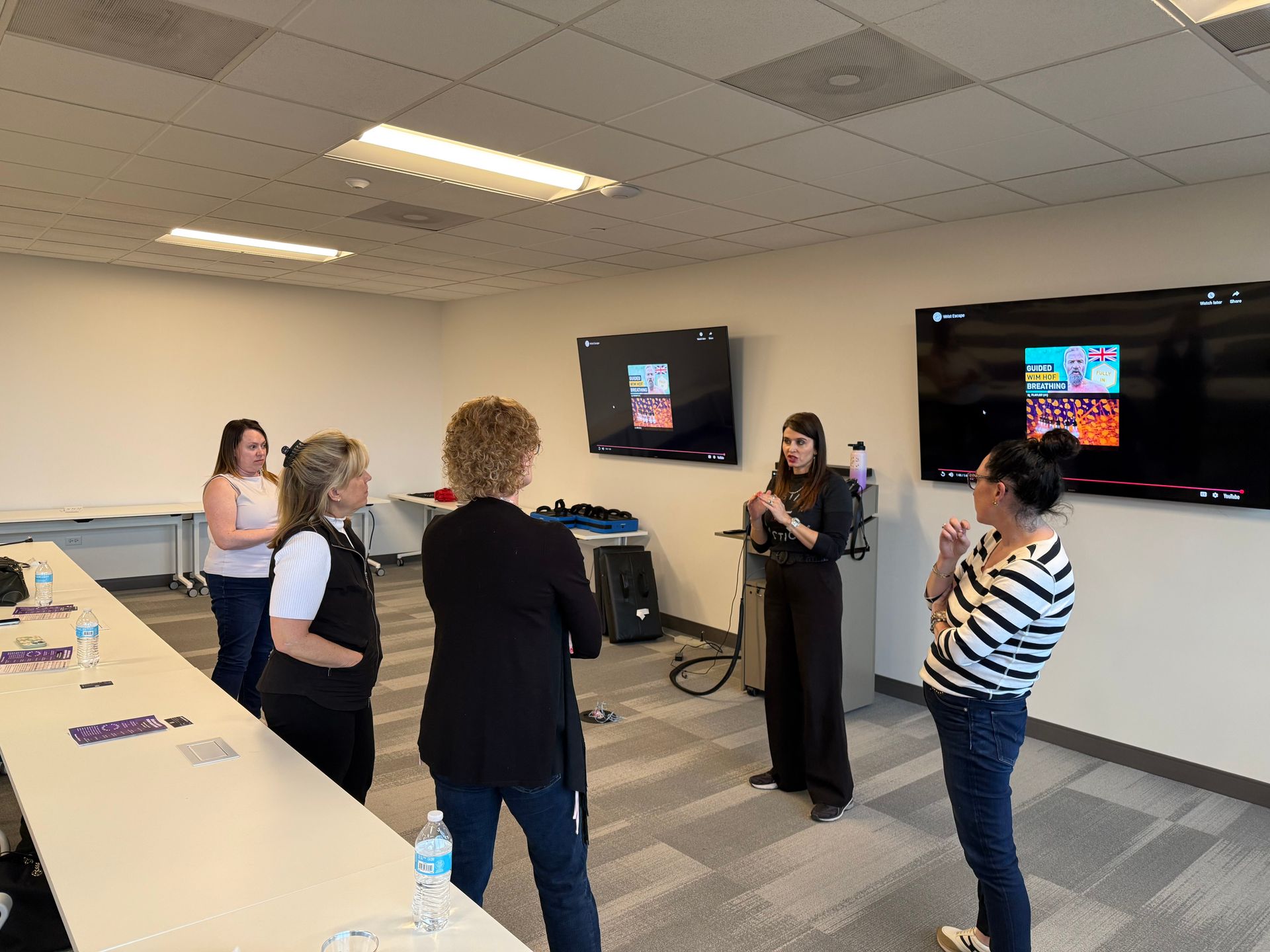 Amanda Hardin speaking to group of women during training session at indoor classroom.