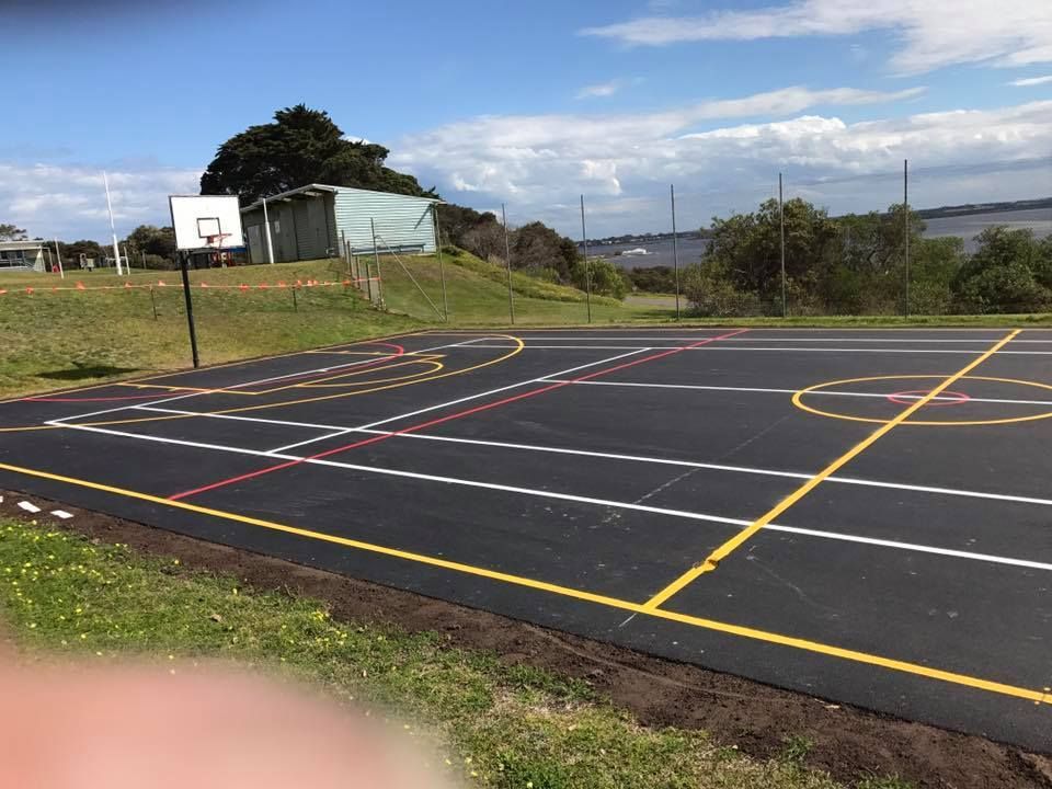 A basketball court with a basketball hoop in the middle of it.