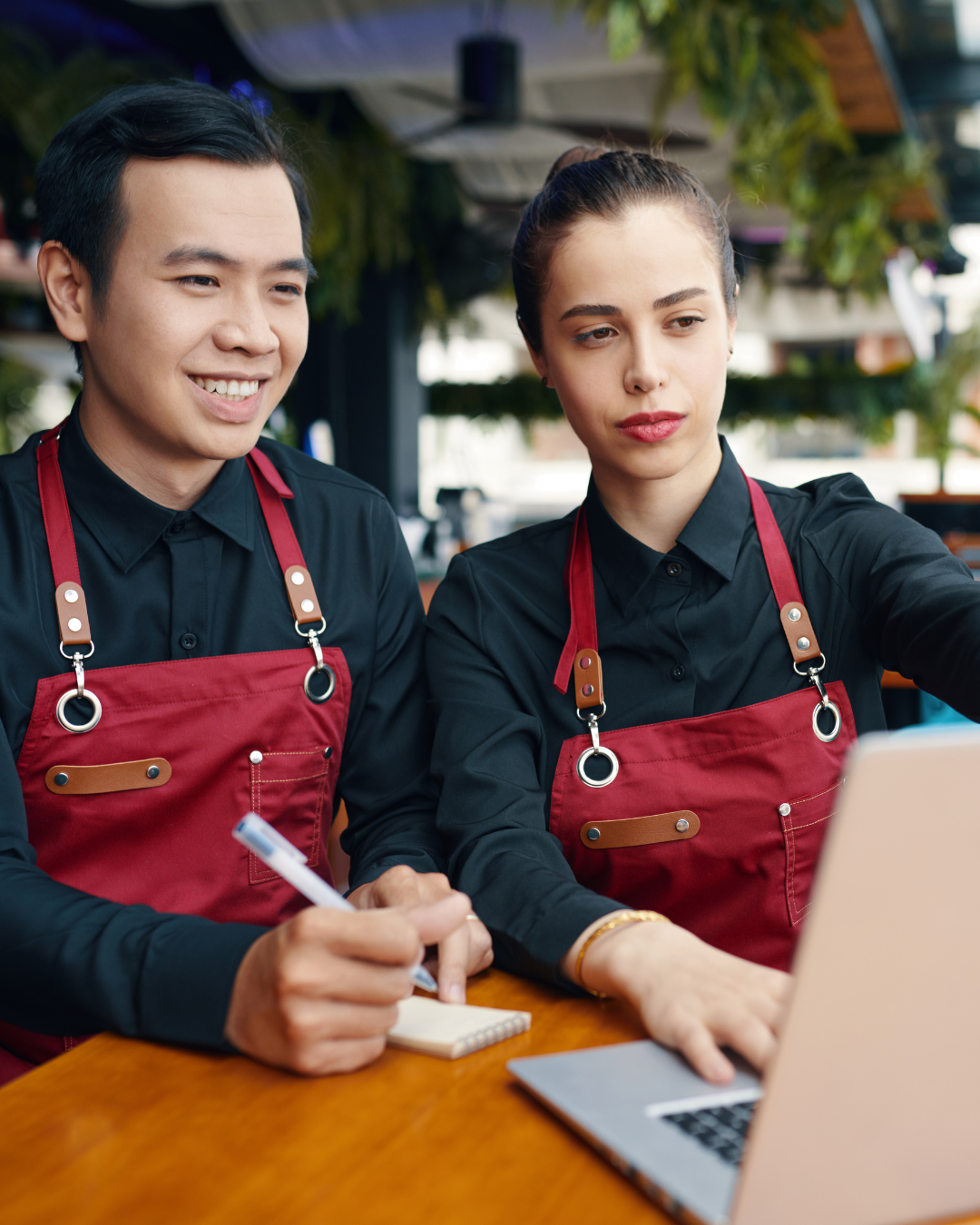 man and woman in red apron