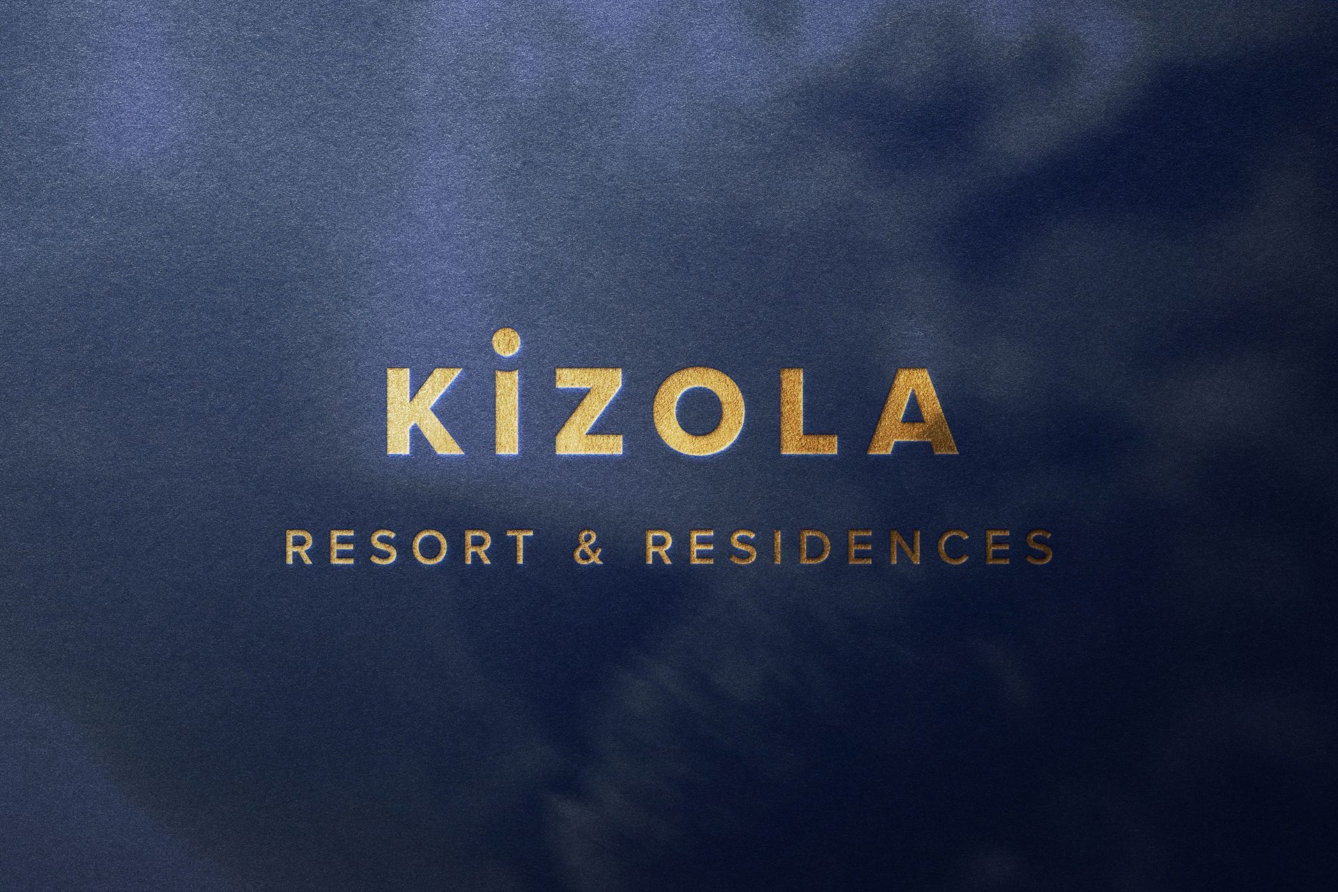 Kizola Resort and Residences gold foil logo design debossed into dark blue fabric hardbacked cover