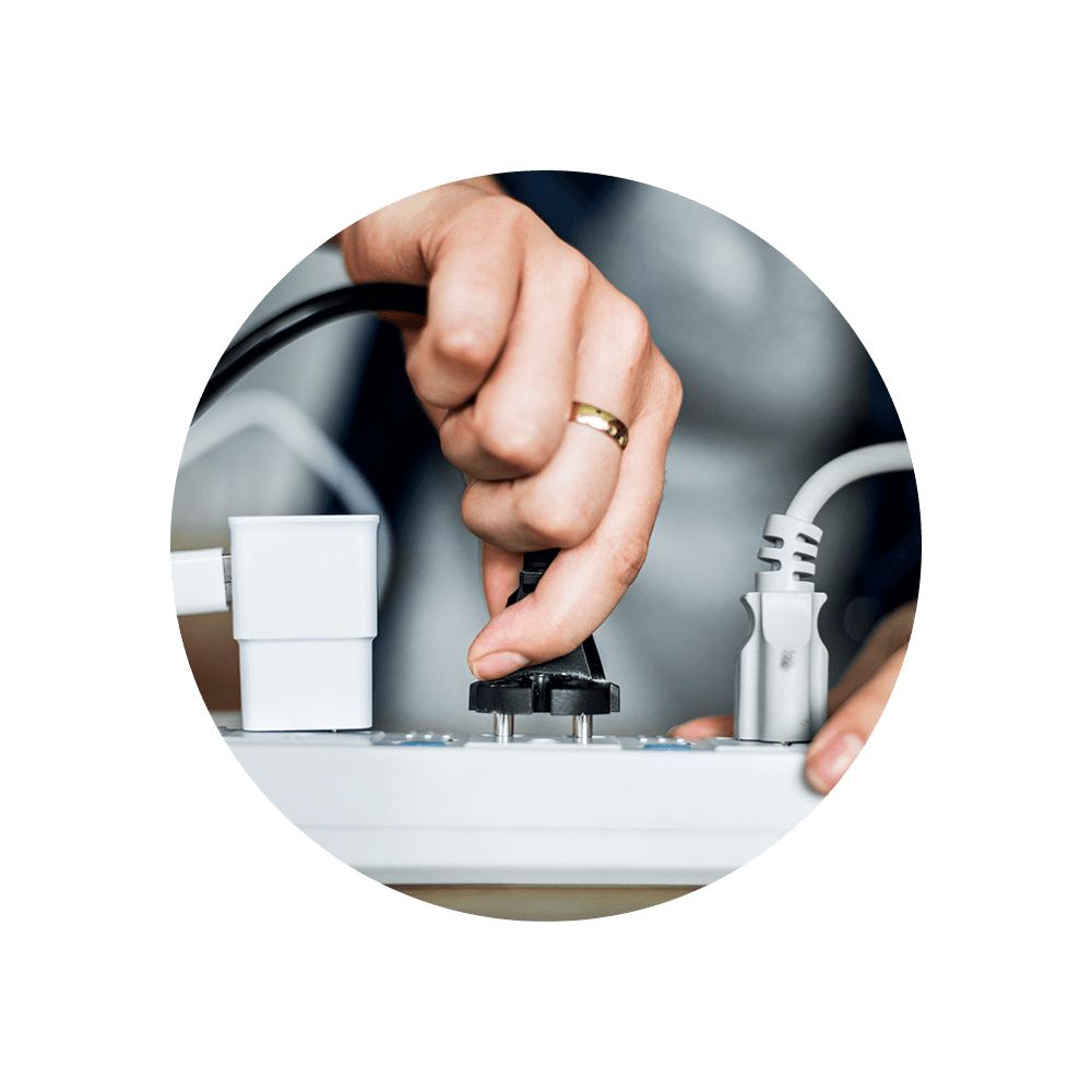 Woman Plugging the Wire to the Outlet — Mustang, OK — Shriver Electric, LLC Woman Plugging the Wire to the Outlet — Mustang, OK — Shriver Electric, LLC