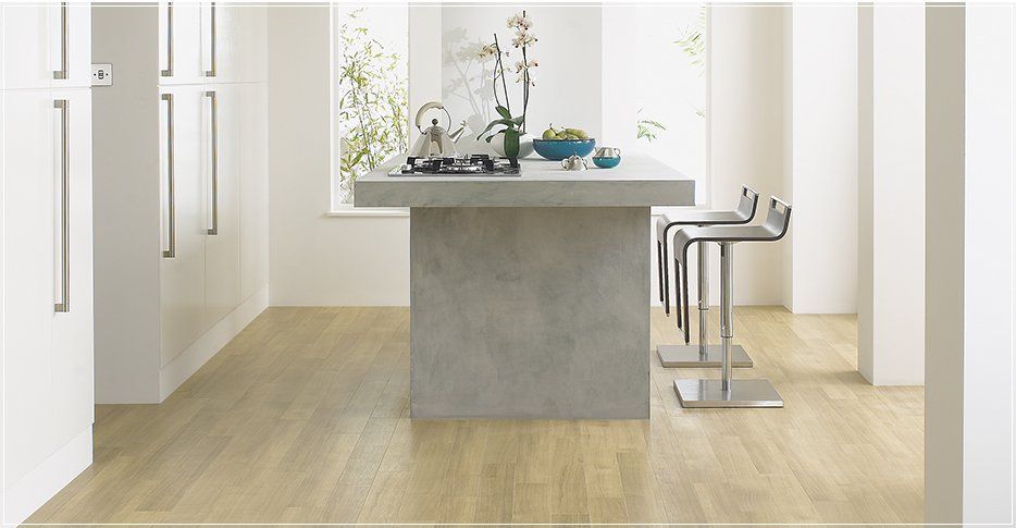Interior Flooring Newbury |A kitchen with a concrete island and stools
