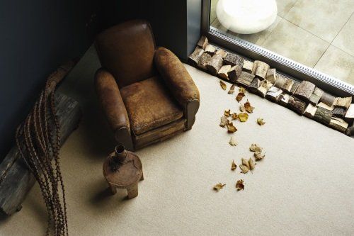 Interior Flooring Newbury |A brown leather chair sits on a carpeted floor next to a window