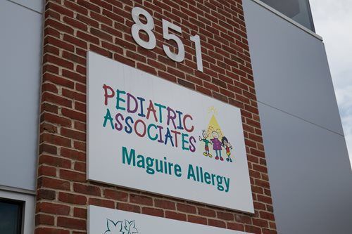 Brick building sign for Pediatric Associates and Maguire Allergy, with address 851.
