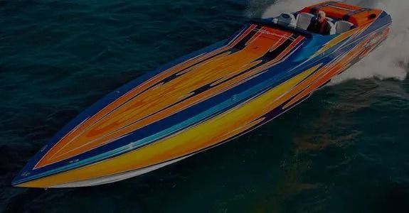 Colorful speedboat racing across dark water, leaving a white wake.