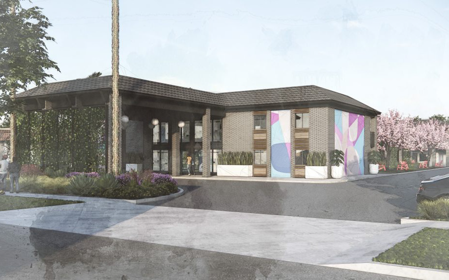 Modern single-story building with large windows and a colorful mural near a curved driveway.