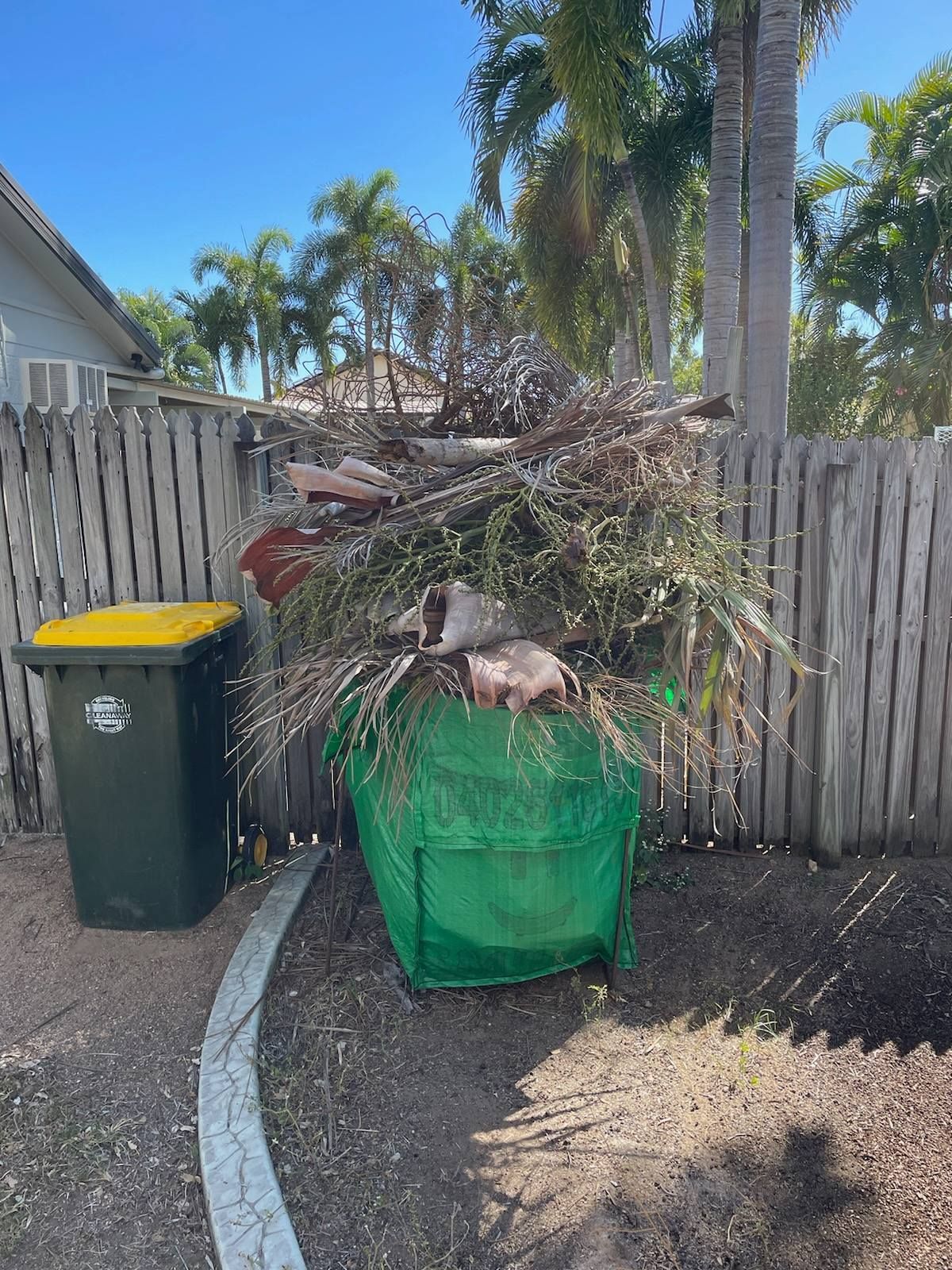 Green Bin Overflowing with Tree Branches and Yard Debris — Green Waste in Thuringowa Central, QLD