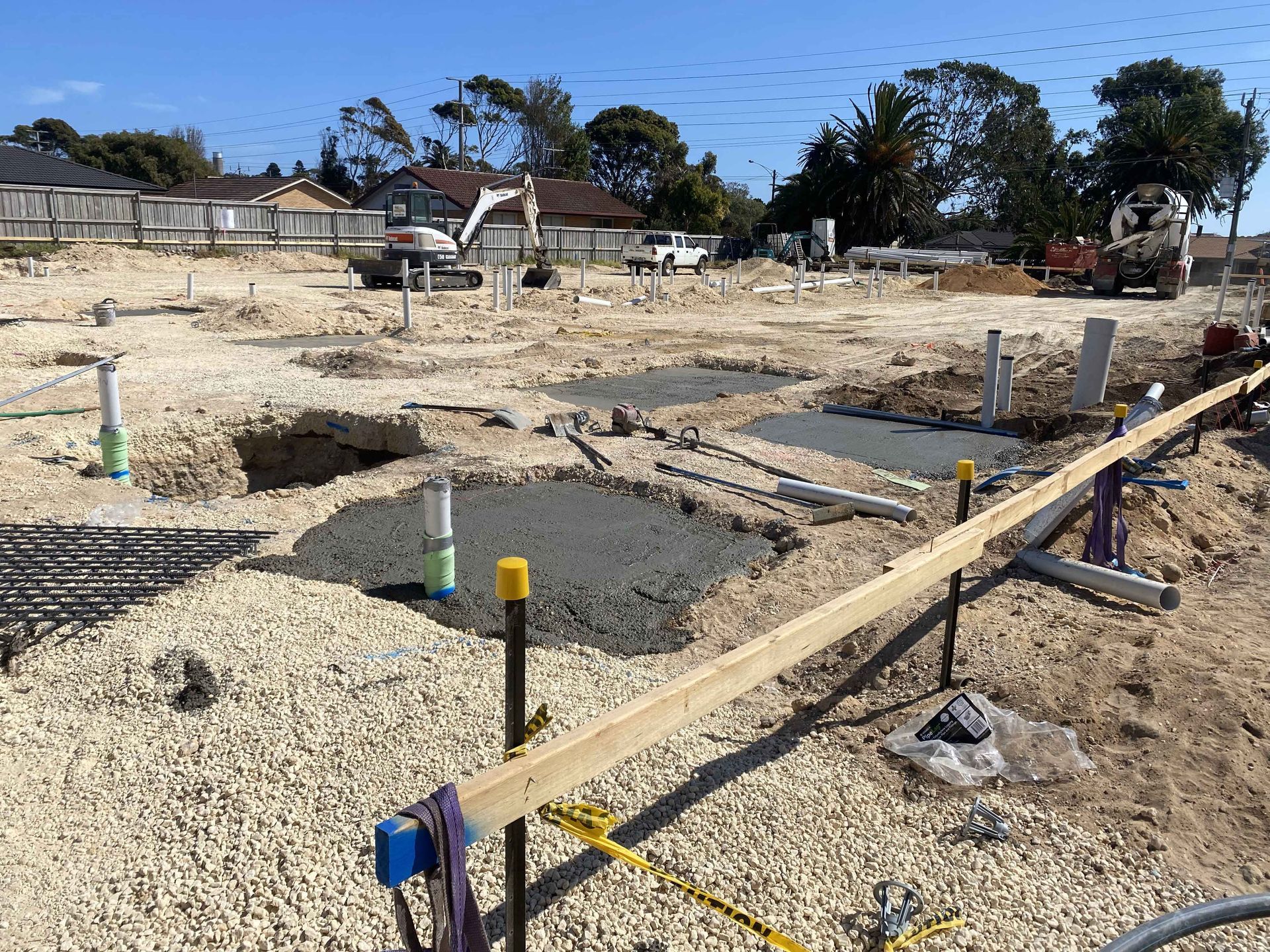 A construction site with a lot of dirt and a truck in the background.