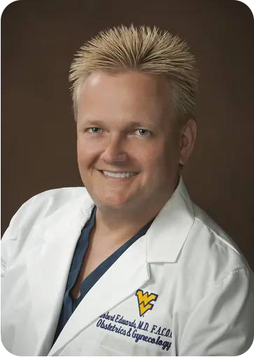 A doctor is holding a model of the female reproductive system.