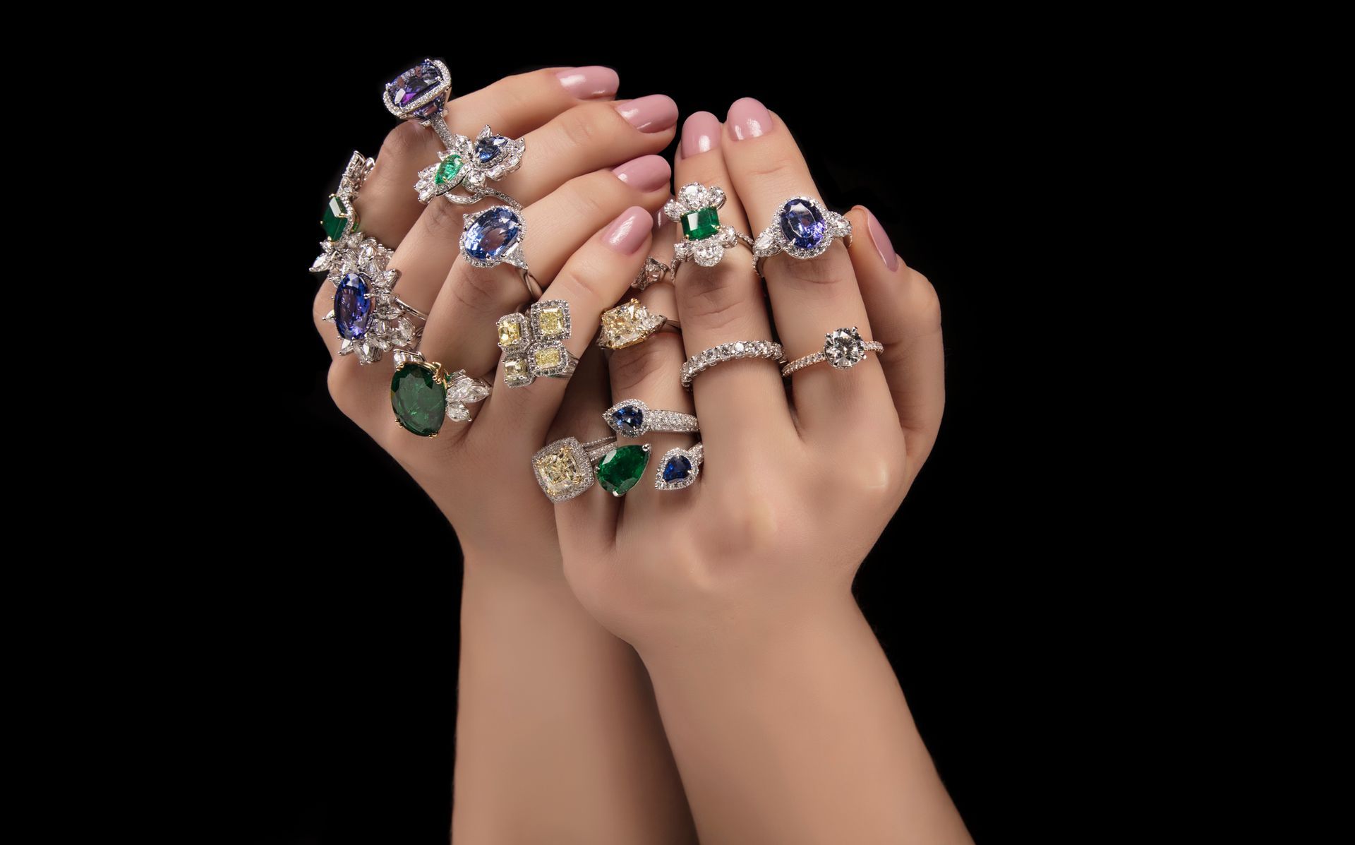 A woman is holding a bunch of rings in her hands.