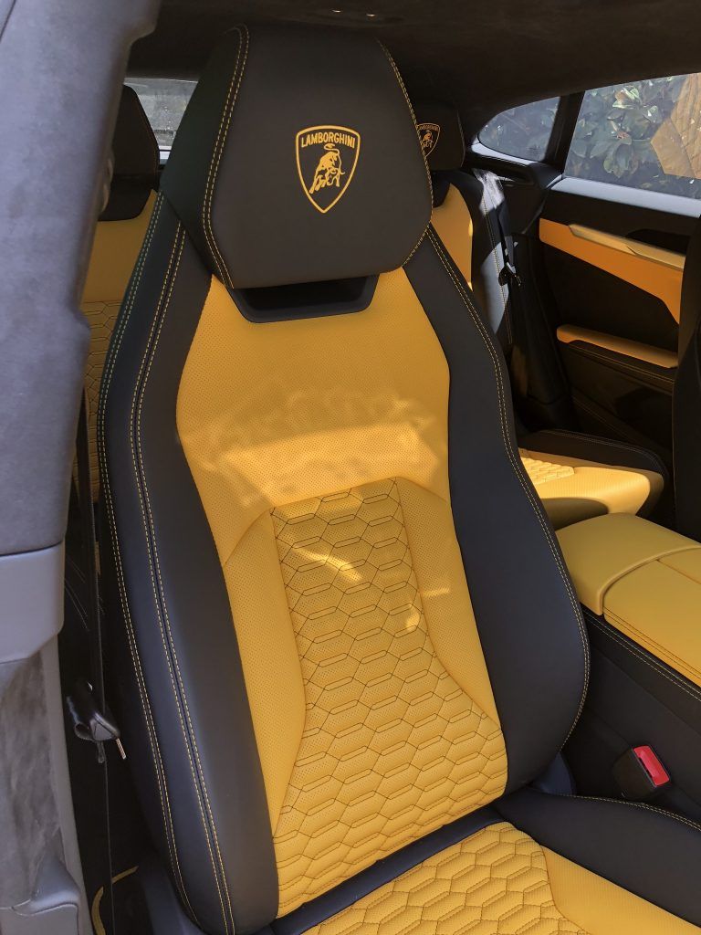 A black and yellow car seat with a lamborghini logo on it