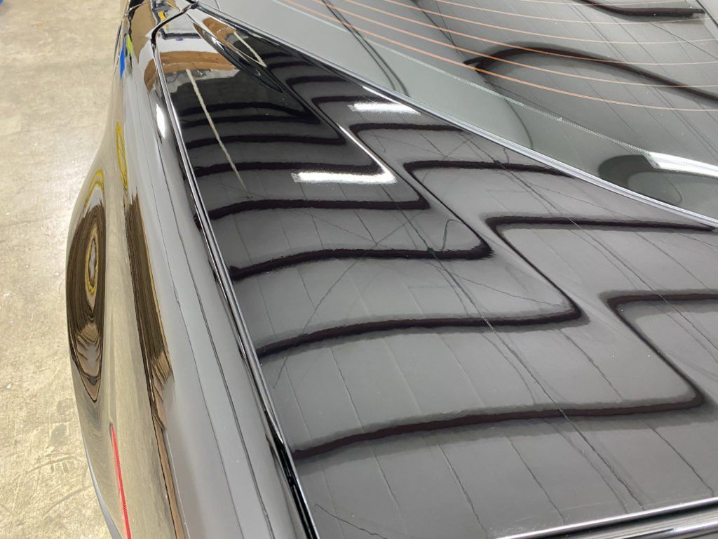A close up of the roof of a black car.