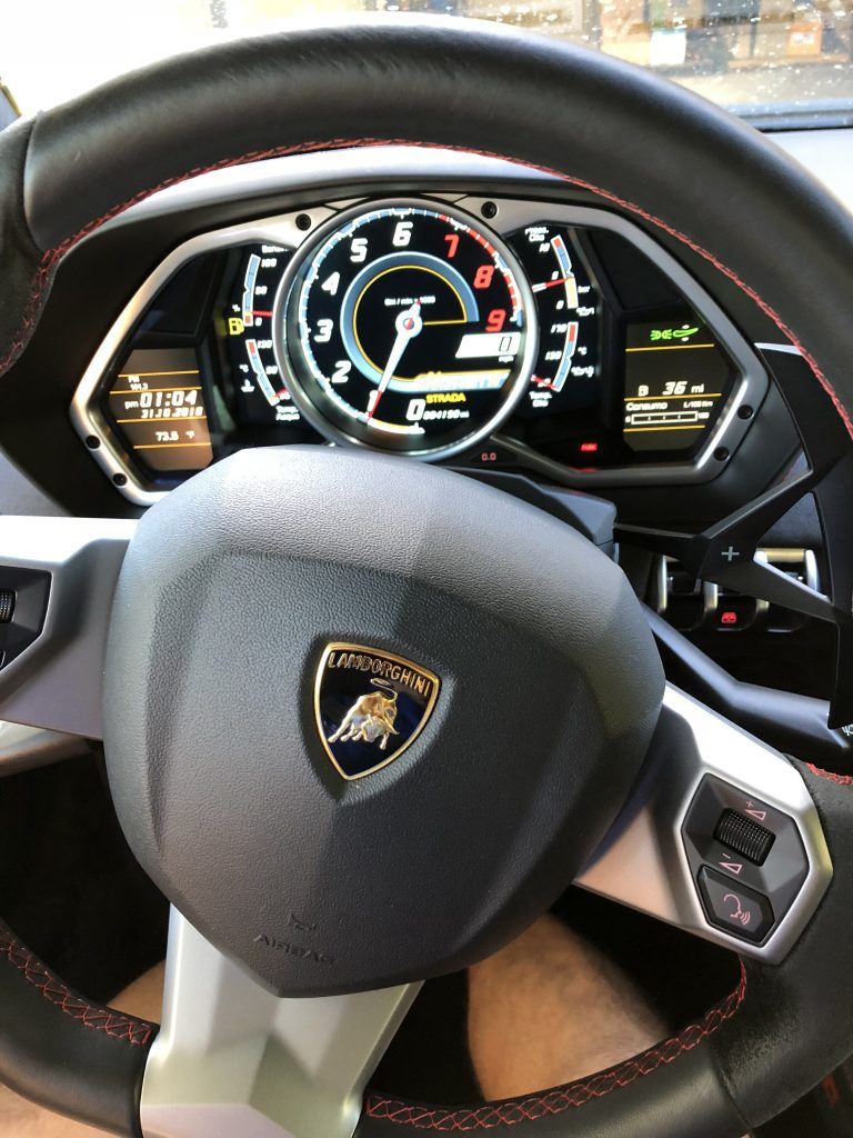 A steering wheel with a lamborghini logo on it