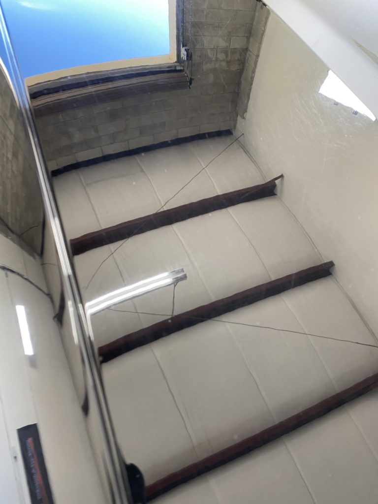 Looking up at the ceiling of a building with a blue sky in the background
