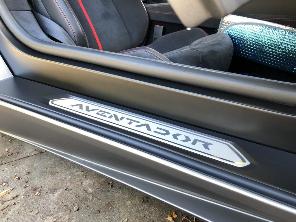 The door sill of a black lamborghini aventador
