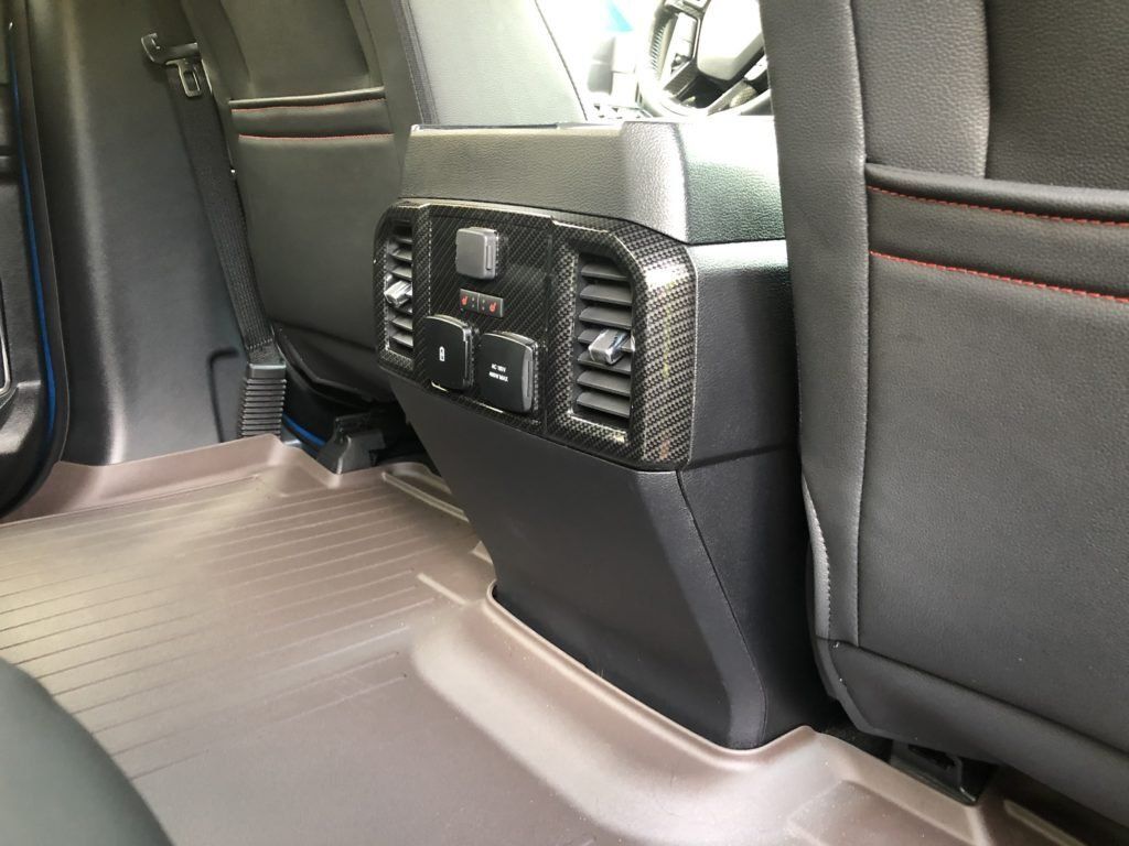 The back seat of a car has a rear air vent