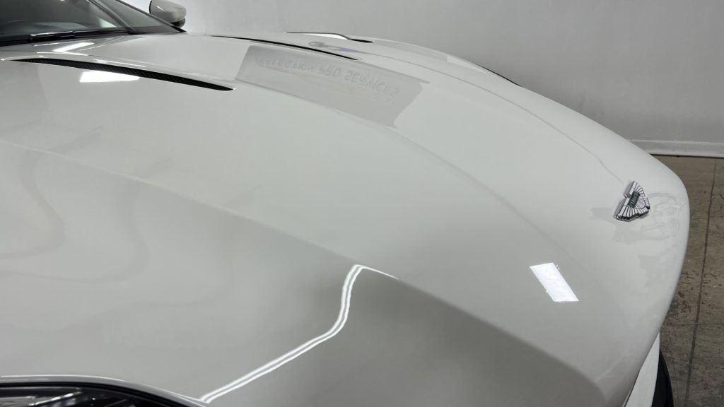 A close up of the hood of a white car.