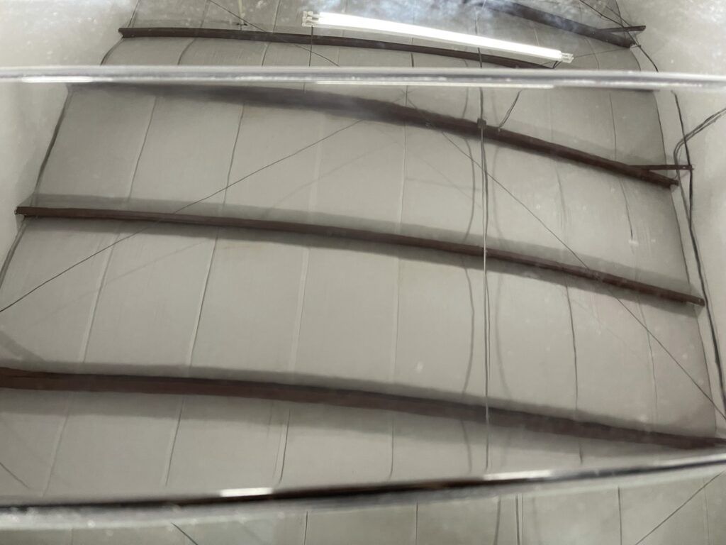 A close up of a staircase with a clear glass railing.