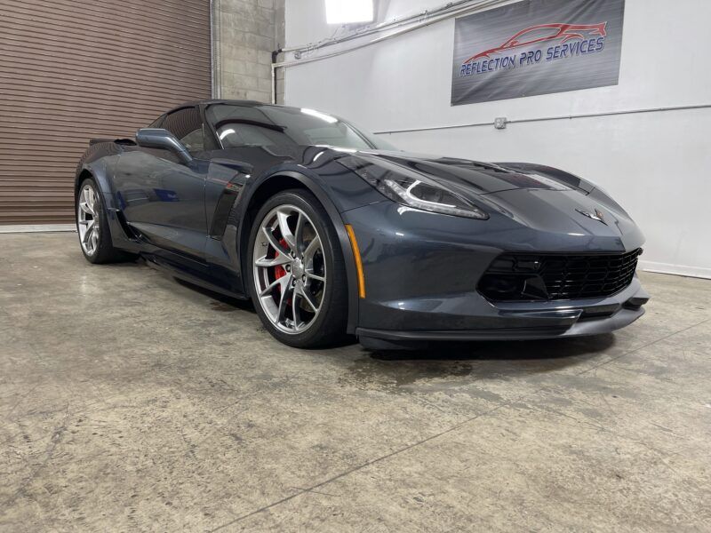 A gray corvette zr1 is parked in a garage.