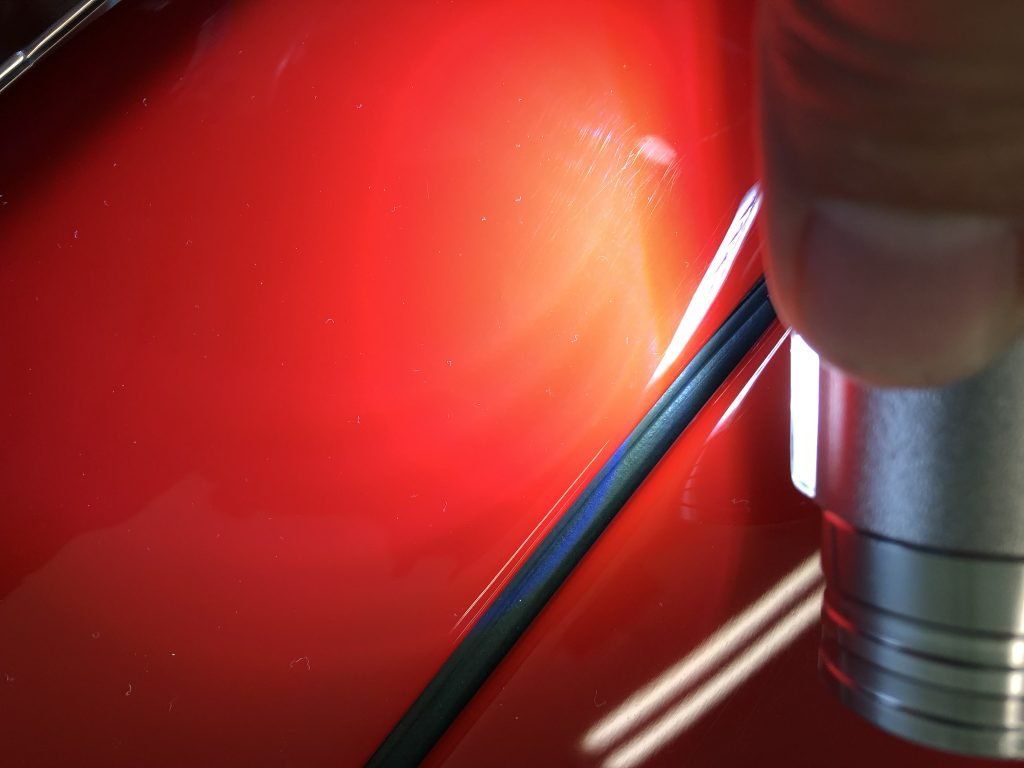 A close up of a red object with a light shining on it