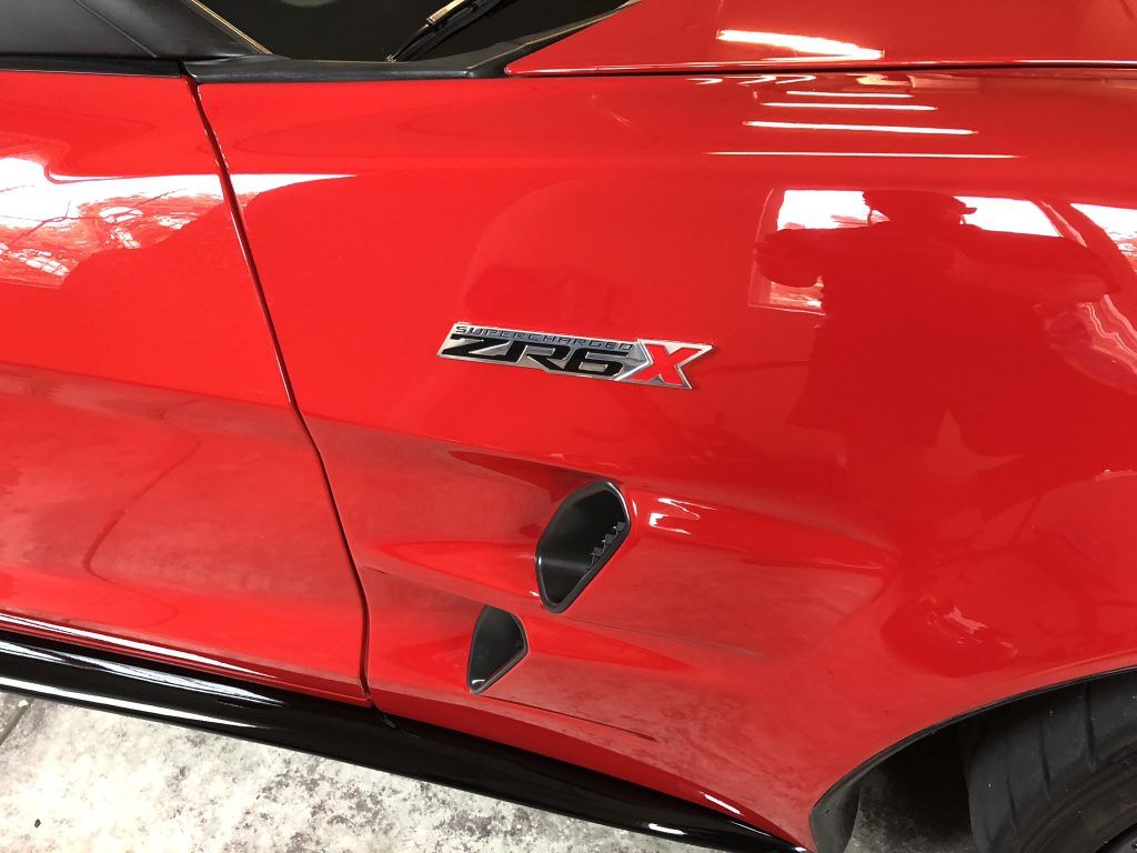 A red car with a zr6 emblem on the side