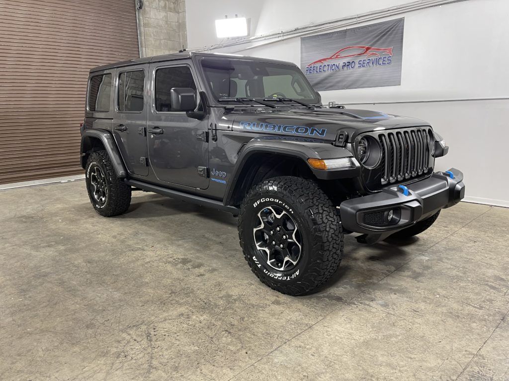 A jeep wrangler is parked in a garage.