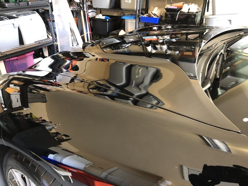A car is being worked on in a garage.