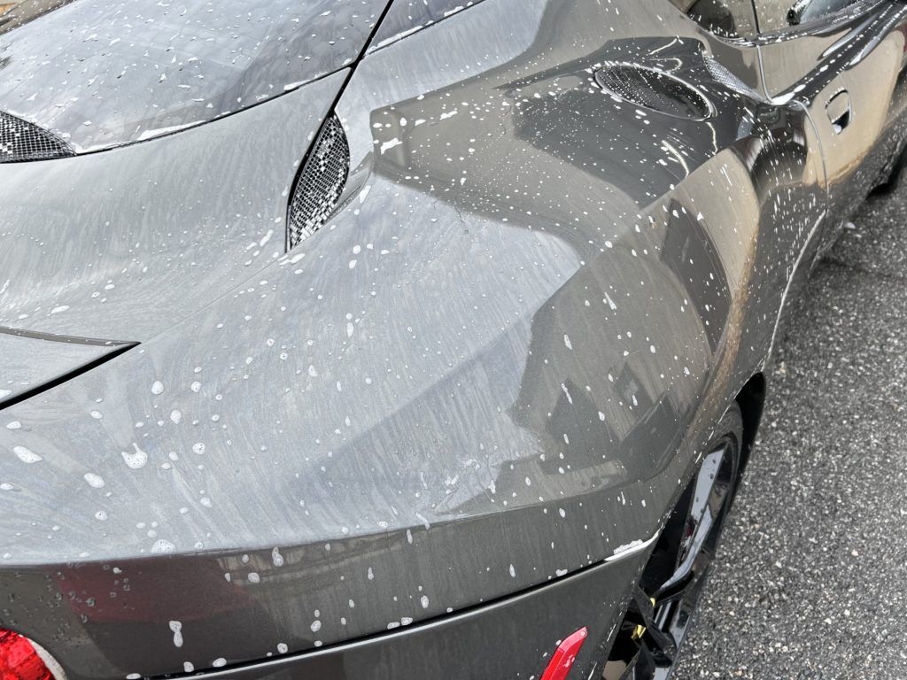 A close up of a car with a lot of white spots on it.