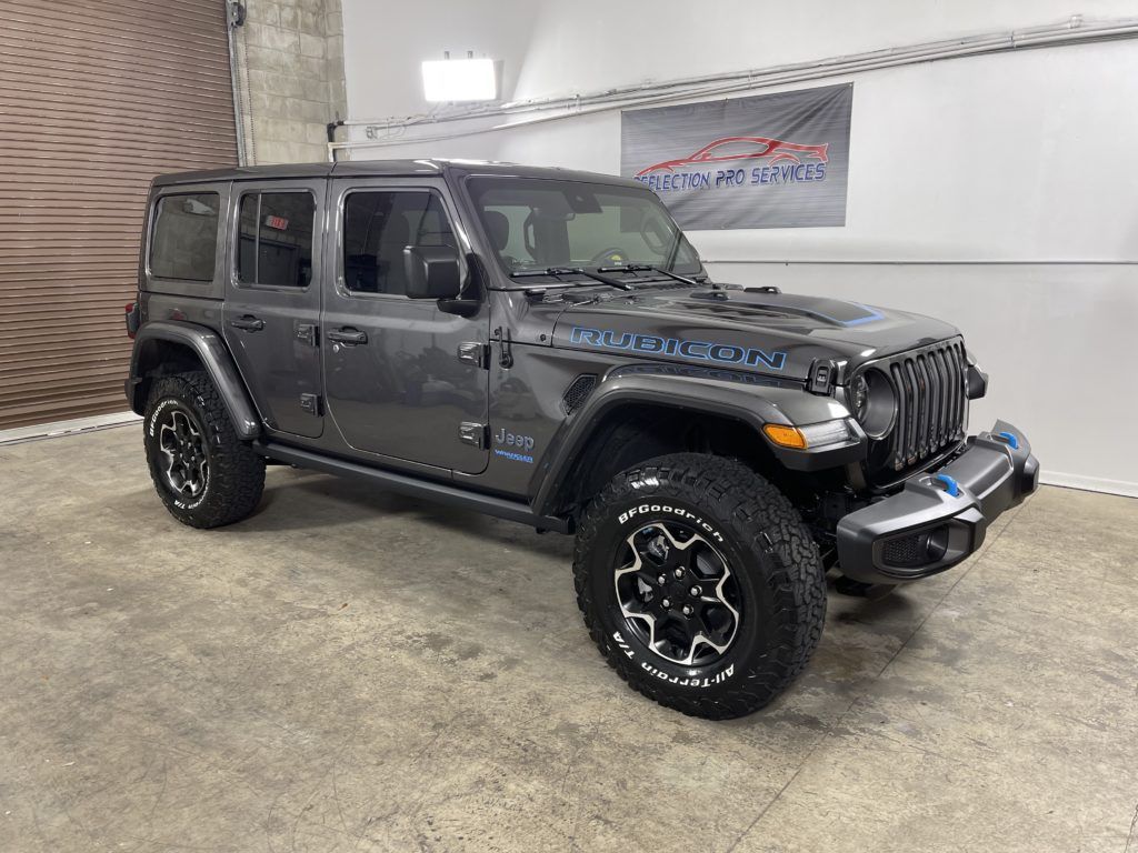 A jeep wrangler is parked in a garage.
