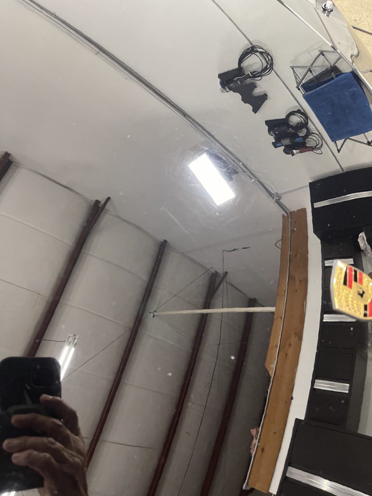 A person is taking a picture of their reflection in a mirror.