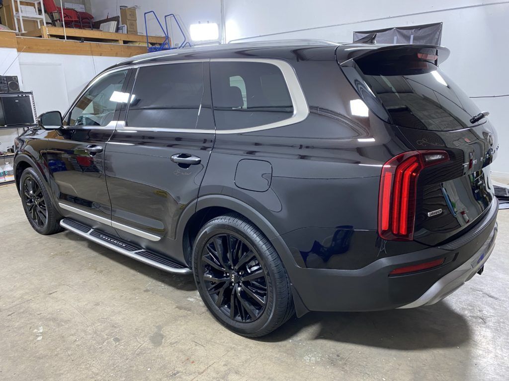 A black suv is parked in a garage.