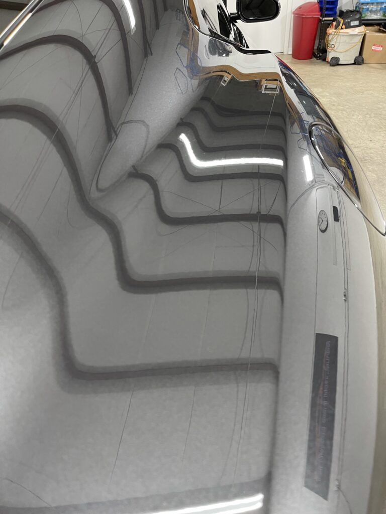 A close up of the hood of a car in a garage