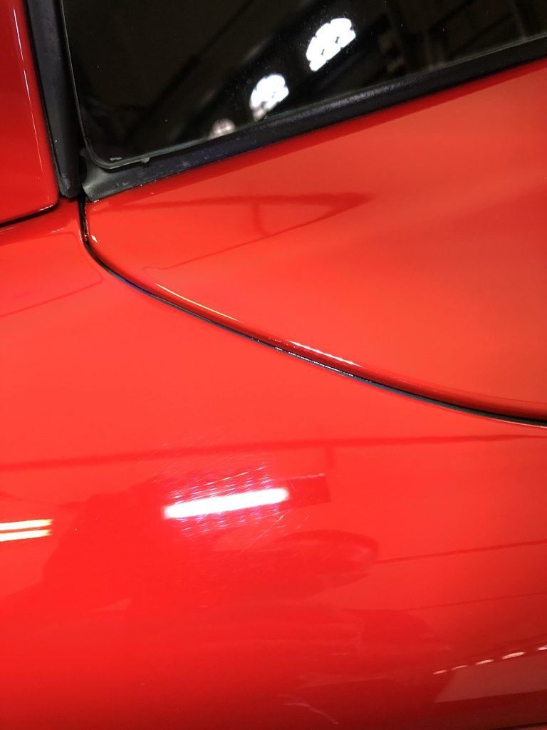 A close up of a red car with a black trim