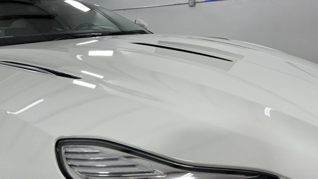 A close up of the hood of a white car.