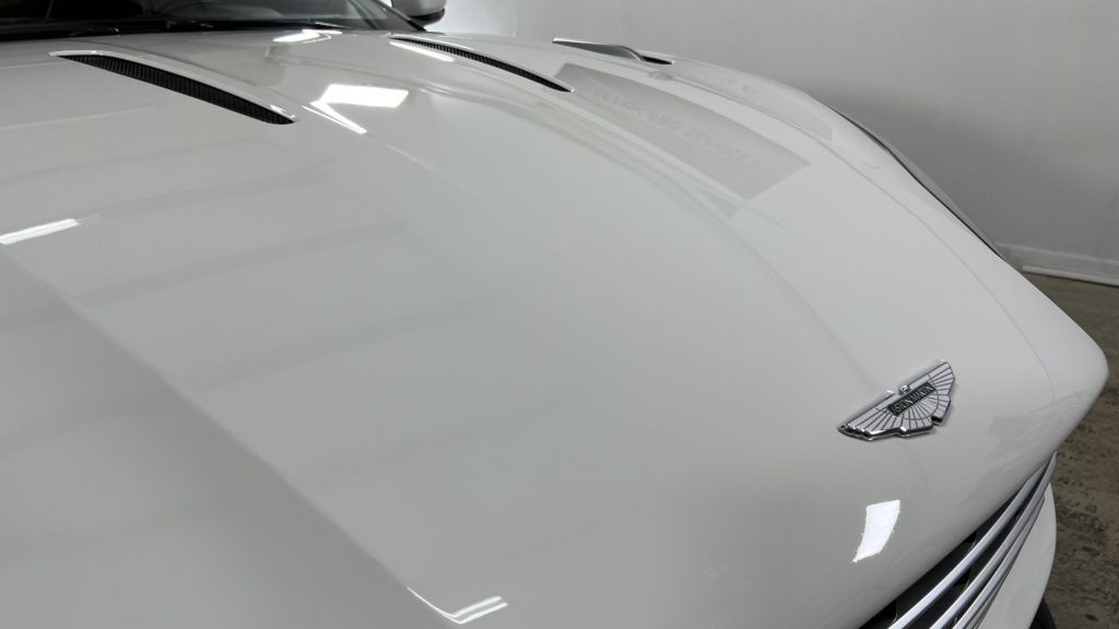 A close up of the hood of a white car.